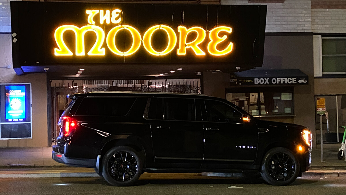 Starline's luxury SUV parked in front of The Moore theater